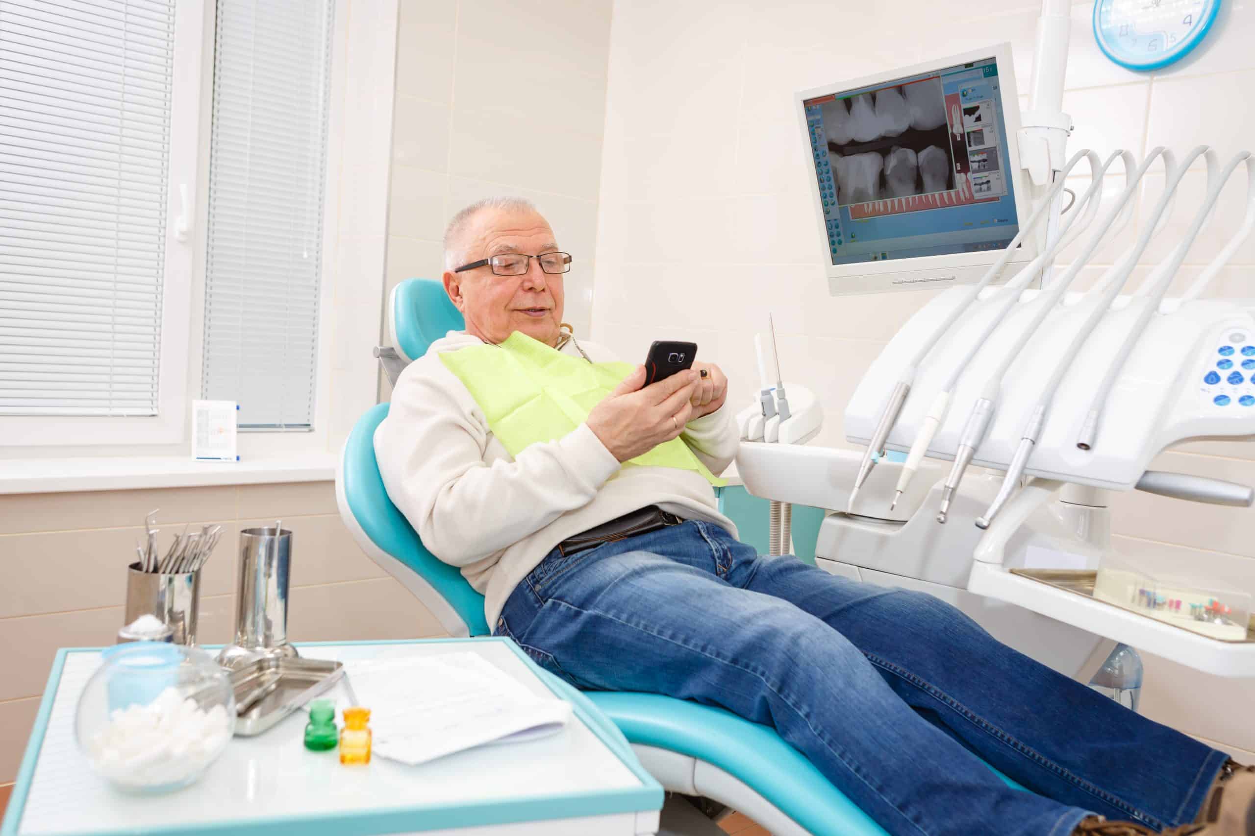 Old,senior,man,sitting,in,a,chair,in,dental,clinic