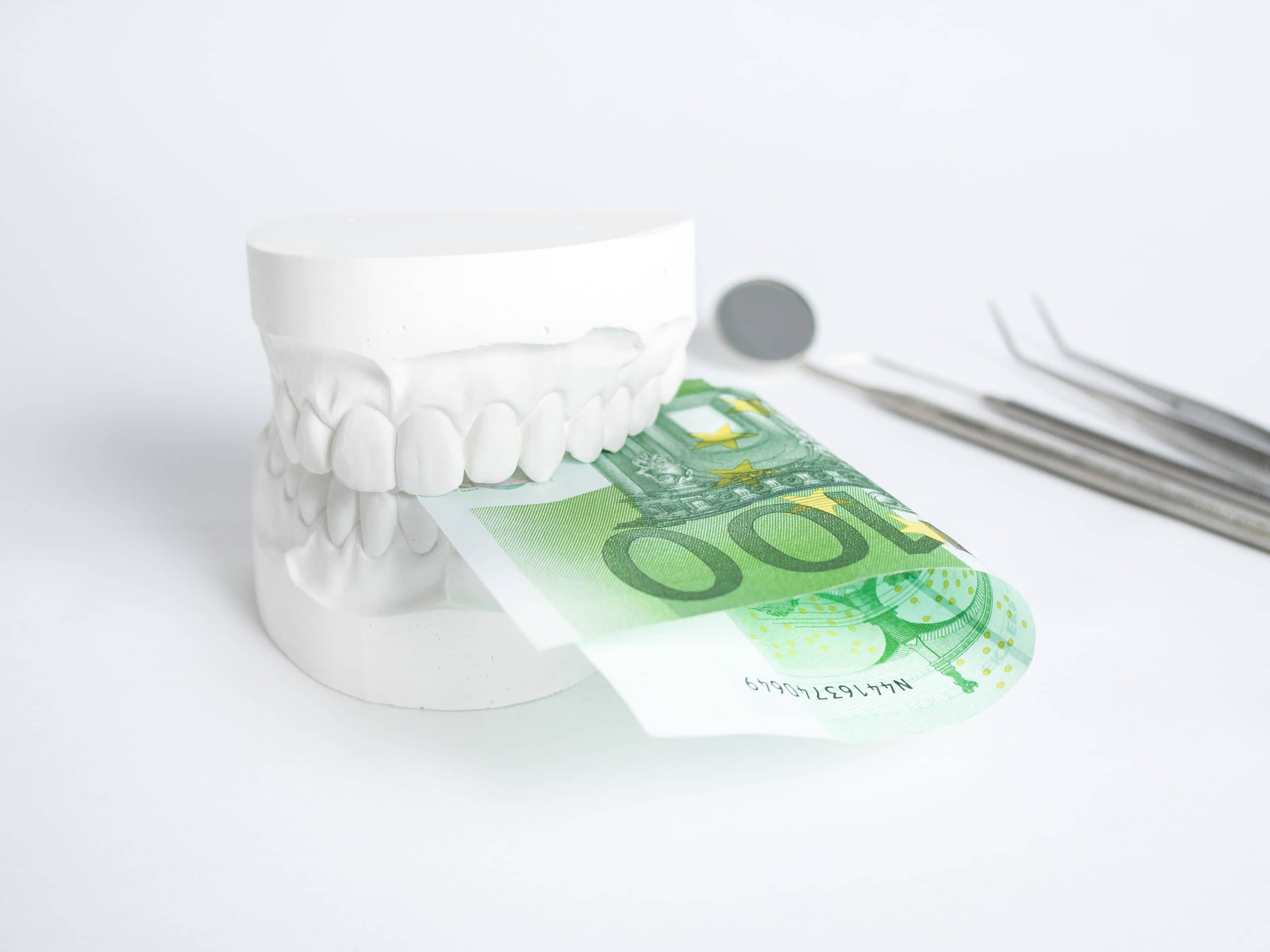 The,denture,with,tooth,money,in,euros,on,white,backgrund